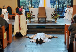 Friar Gabriel Mary Scasino lies prostrate as a sign of humility as the congregation invokes the intercession of the communion of saints in the singing of the Litany of Saints. Photo By Lee Depkin